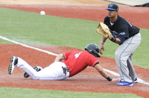 Lake Erie Crushers' Joey Burney slides safely back into first as Windy City ThunderBolts' first baseman Davidson Peguero attempts to pick him off.  KRISTIN BAUER | CHRONICLE
